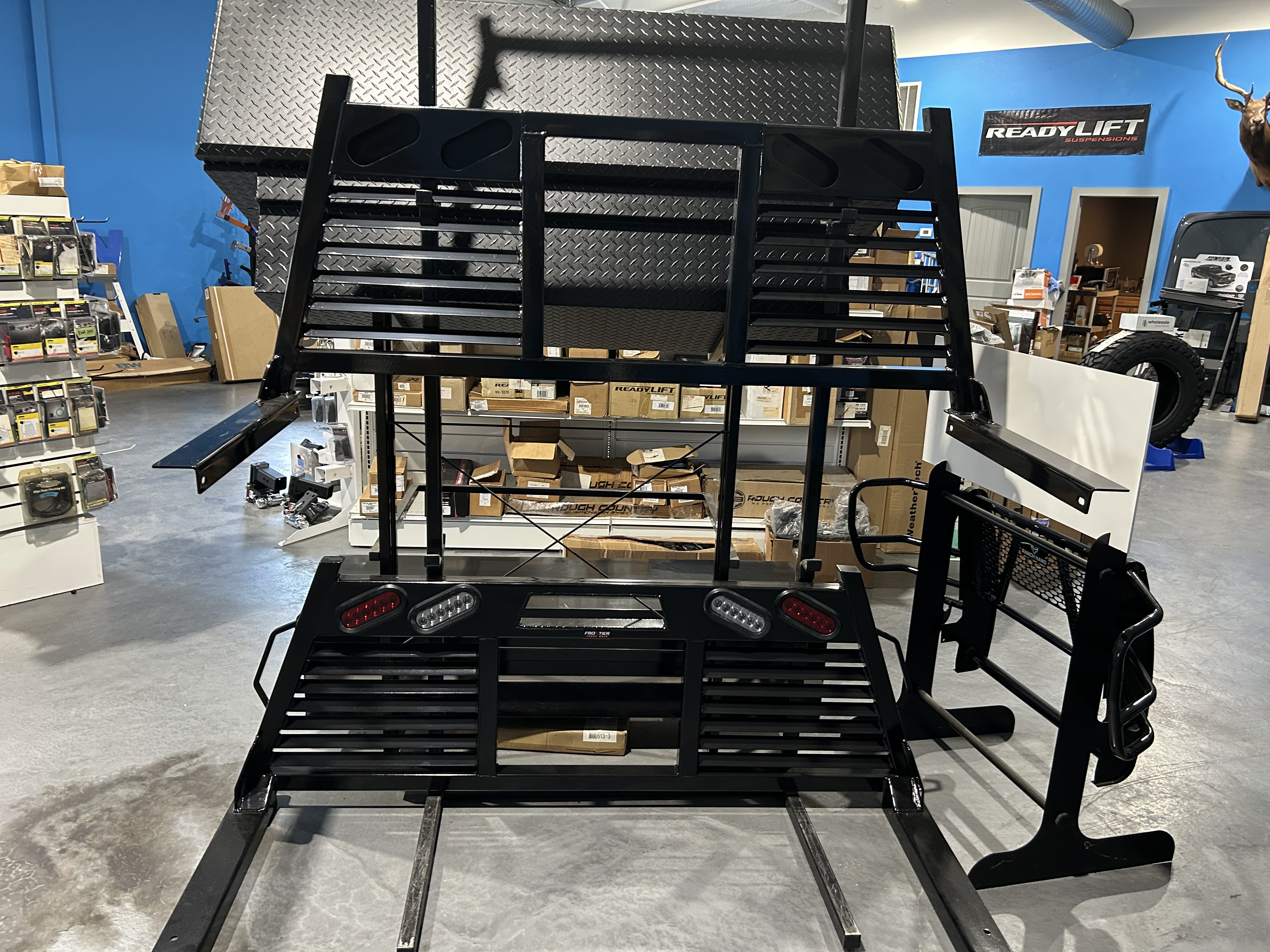 Multiple headache racks and cab racks on display at Truck Country Outfitters showroom in Marble Falls TX