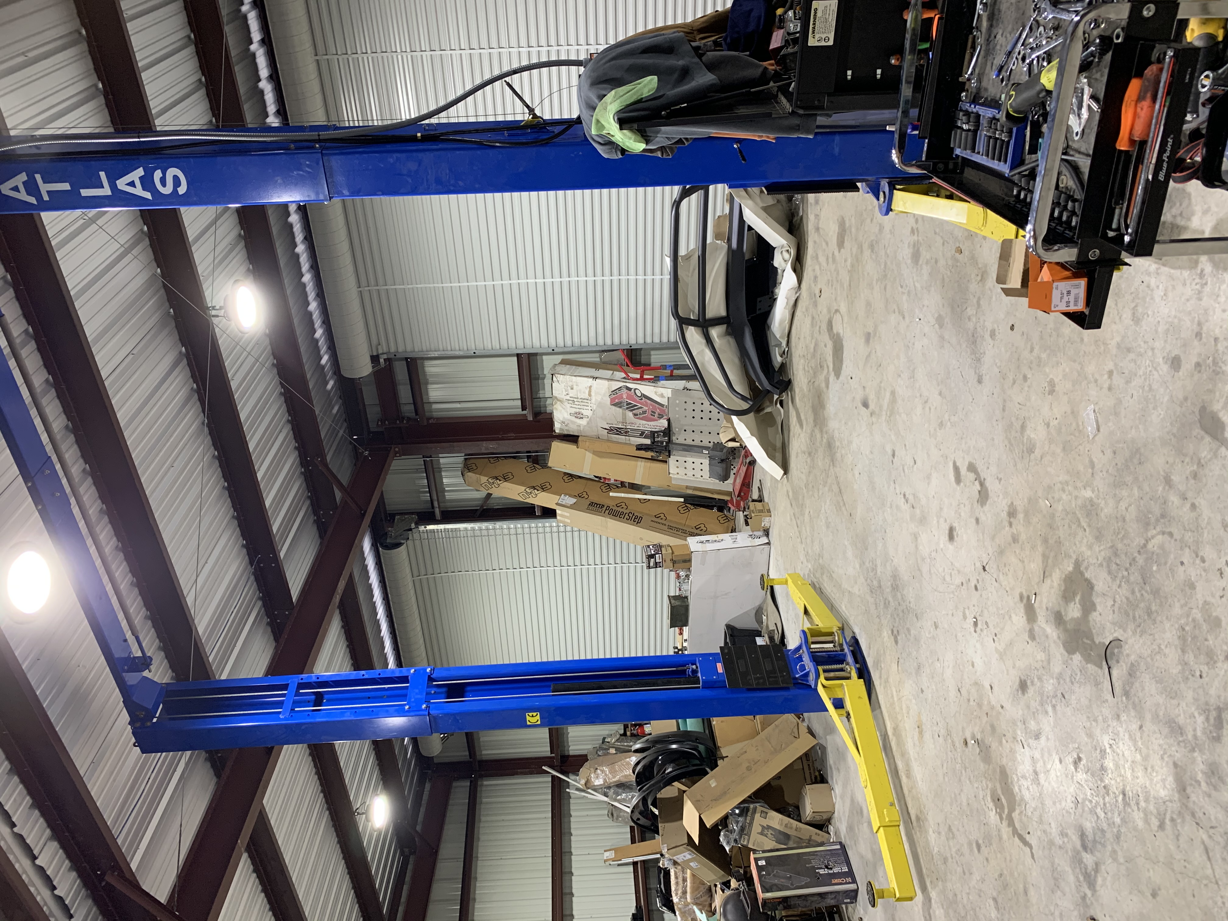 Atlas 2-post commercial vehicle lift with Blue-Point tool cart — installation bay at Truck Country Outfitters